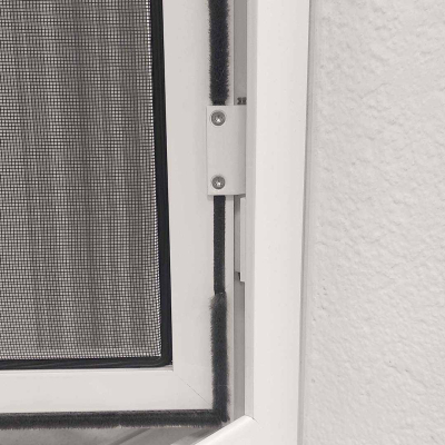 Fliegengitter, befestigt, an weißem Fensterrahmen.